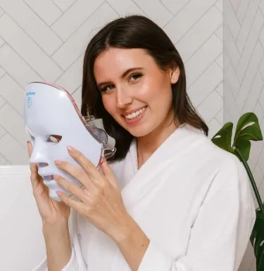 Woman holding the Glokore LED face mask